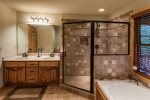 Master bathroom with large jetted tub and custom tiled shower
